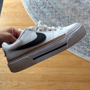 Nike White Low-Top Sneakers with Black Swoosh and Gold Accent